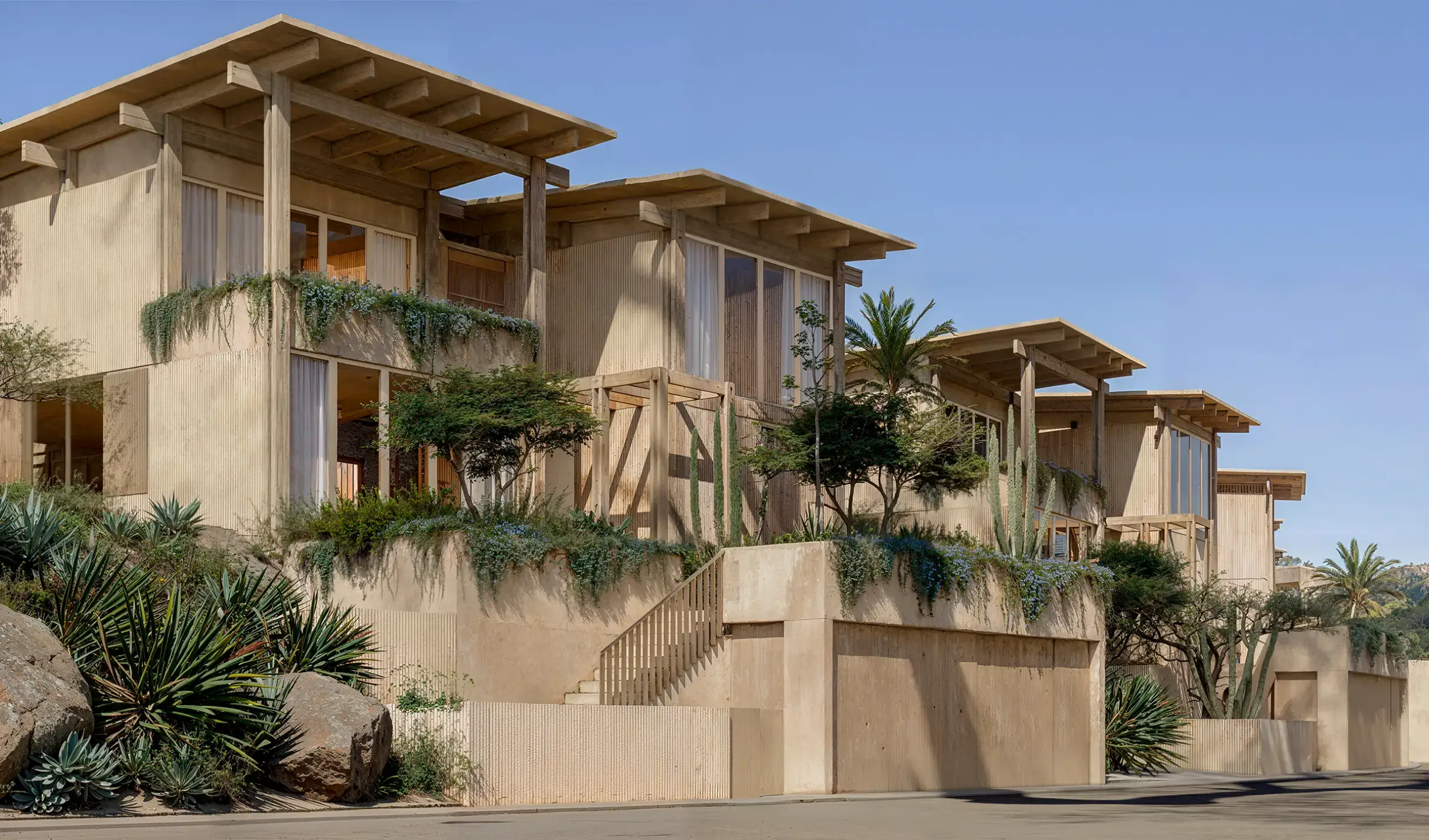 Modern homes in Cabo real estate for sale featuring cliffside architecture and panoramic ocean views