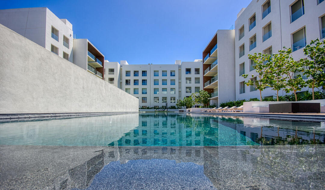 Los Cabos Brisas Del Tezal Ready for delivery! Brisas del Tezal ground-floor condo featuring 2 bedrooms and 2 bathrooms in an exclusive low-density community of 36 units across two 4-story elevator buildings. Located minutes from Medano Beach and downtown Cabo. Showcases excellent construction quality and craftsmanship from the developer, including parota wood carpentry and a large, solid front door. Features marble flooring throughout, spacious balcony, granite countertops and backsplash in the kitchen, pantry, bathrooms with marble showers to the ceiling, wall-to-wall closets, and a laundry room with space for side-by-side washer and dryer, plus manual washing area and storage. Equipped with 1-ton A/C mini-splits in each bedroom and two in the living area. Enjoy sunset for sale