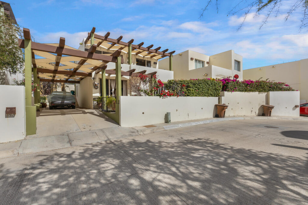 Los Cabos Casa Mex-Agaves Situated within the Casa Mexicana - Agaves community, this thoughtfully designed three-bedroom residence offers a functional and well-planned layout. The main level features a bedroom with an en-suite bathroom and walk-in closet, ideal for guests, multigenerational living, or those seeking stair-free access.A spacious outdoor terrace on the first floor, surrounded by tropical landscaping, provides a serene setting for both relaxation and entertaining. With multiple seating areas, it stands out as a unique feature within Casa Mexicana. The upper level includes two additional bedrooms, each with en-suite bathrooms and walk-in closets, along with the home's main living and kitchen areas. The indoor spaces are seamlessly connected to an additional terrace, enhancing the home's indoor-outdoor living appeal.Additional features include a dedicated laundry area, a two-car garage, and accordion-style hurricane shutters, combining comfort with practicality and peace of mind. – Punta Arena E-7, Cabo Corridor, Cabo Corridor, BS
